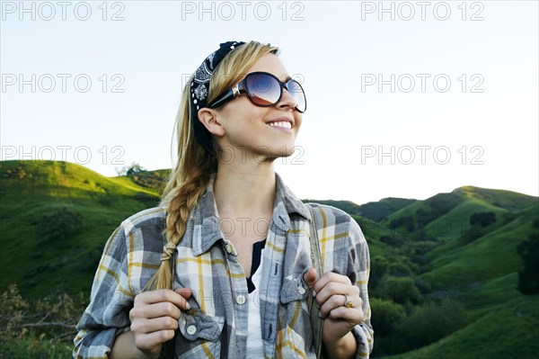 Caucasian woman smiling on rural hilltop