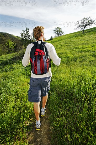 Caucasian man walking on dirt path