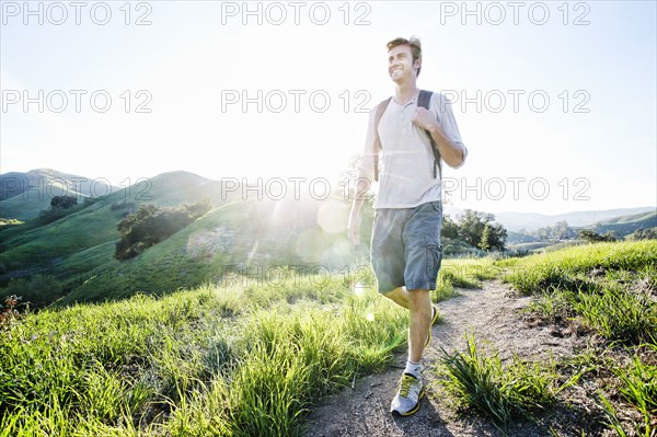 Caucasian man walking on dirt path