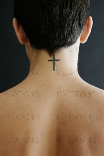Hispanic woman with crucifix tattoo on neck