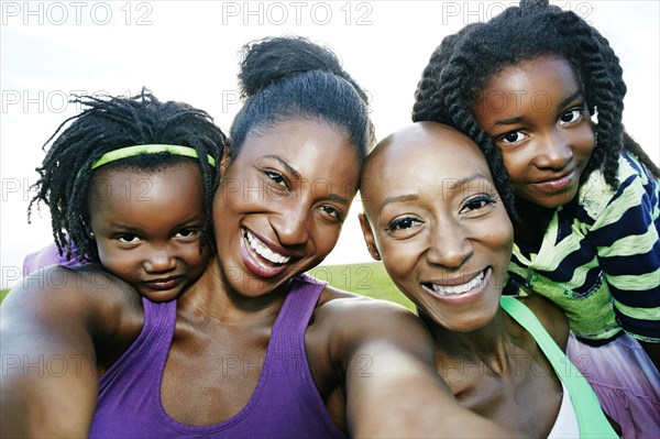 Women and children smiling outdoors