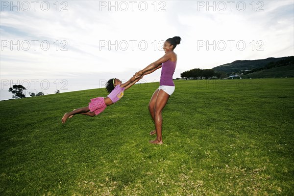 Mother and daughter playing in park