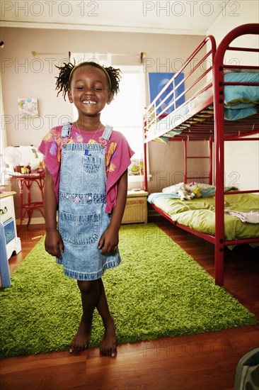 Black girl smiling in bedroom