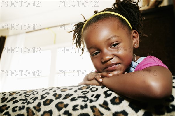 Black girl relaxing on sofa