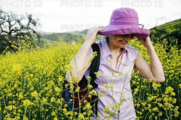 Caucasian woman standing in tall grass