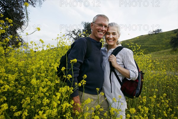 Caucasian couple standing in tall grass