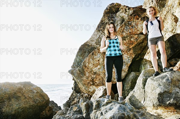 Women hiking on boulders