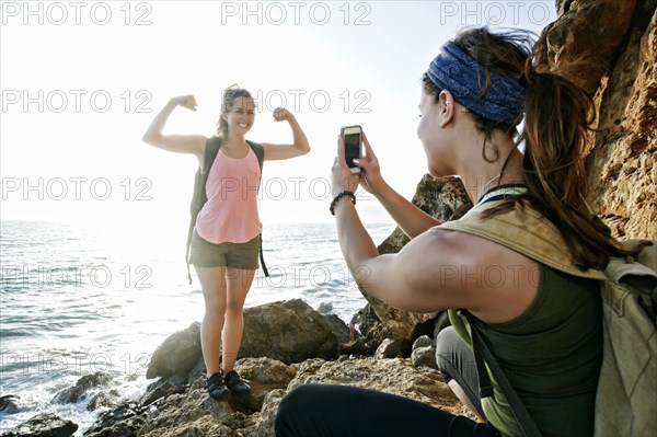 Woman photographing friend outdoors