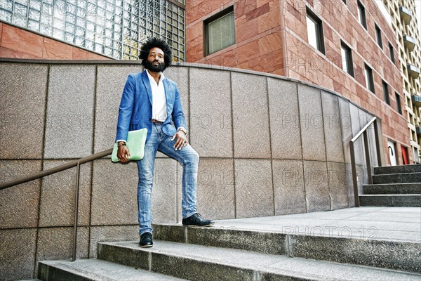 Mixed race businessman standing on steps