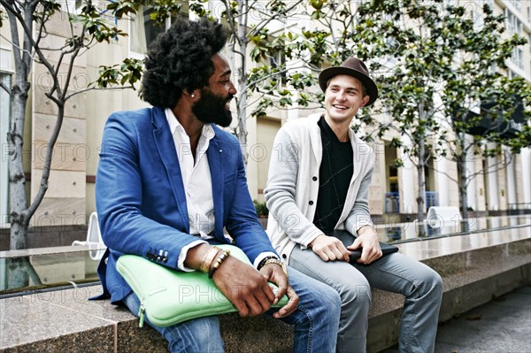 Businessmen sitting on stone bench