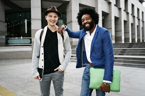 Businessmen smiling in courtyard