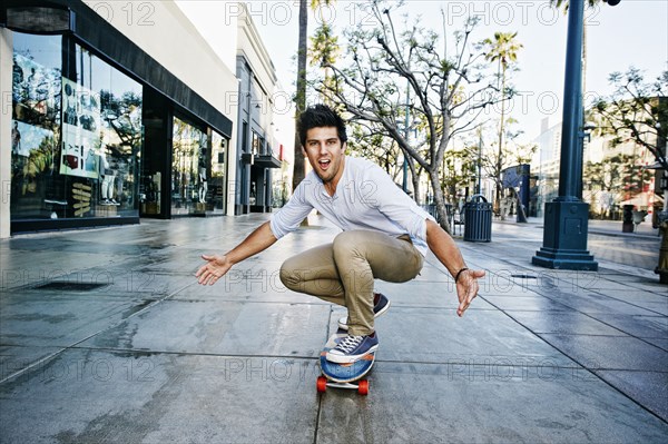 Caucasian man riding skateboard