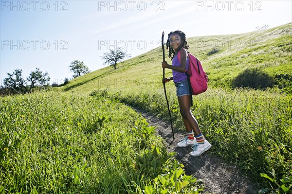 Black girl walking on rural path