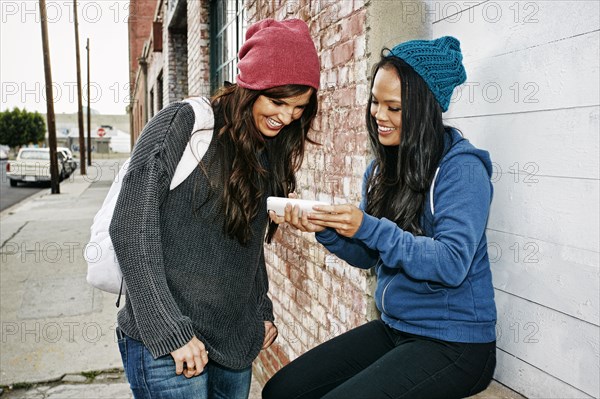 Women using cell phone outdoors