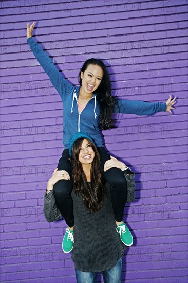 Woman carrying friend on shoulders