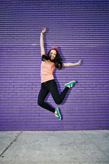 Asian woman jumping for joy