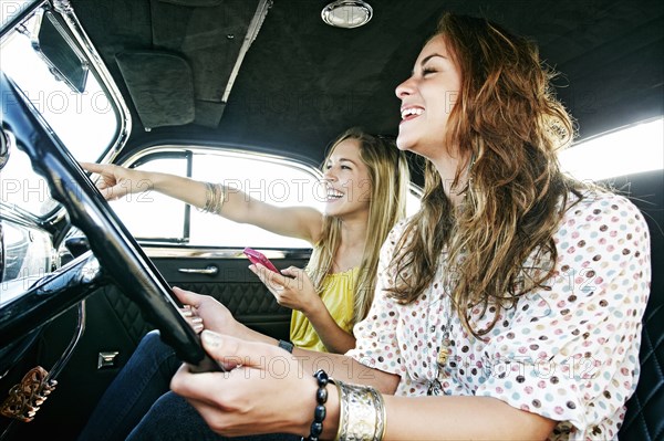 Women driving vintage car