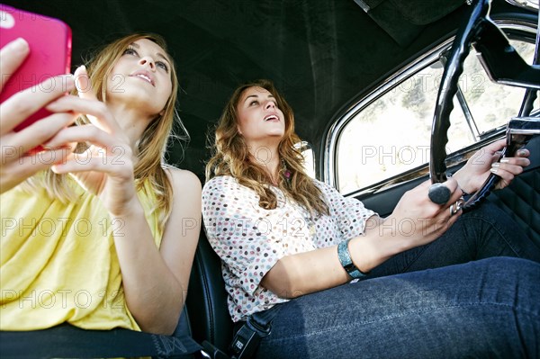 Women driving vintage car