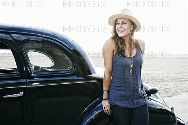 Woman standing near vintage car