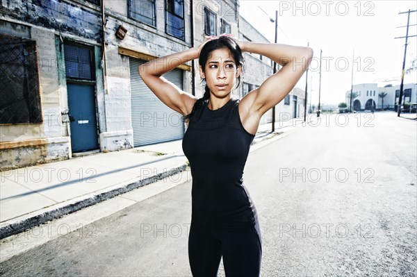 Mixed race woman stretching outdoors