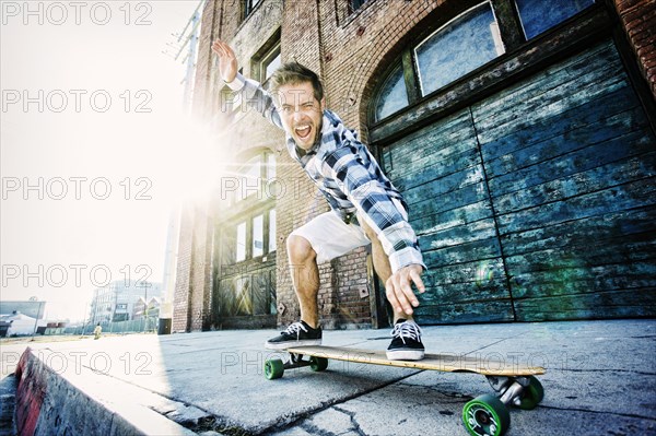 Caucasian man riding skateboard