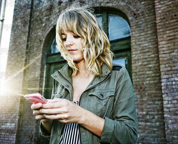 Caucasian woman using cell phone outdoors