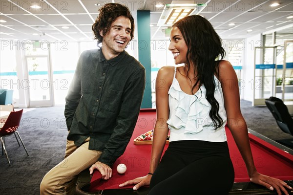 Couple talking at pool table