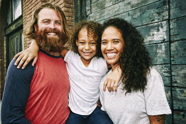 Family hugging outdoors