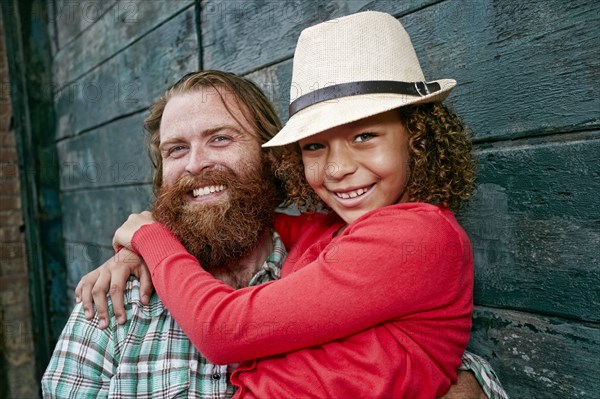 Father and daughter hugging outdoors