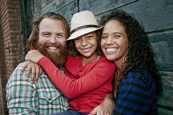 Family hugging outdoors