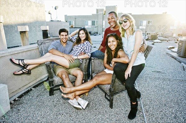 Friends relaxing on urban rooftop