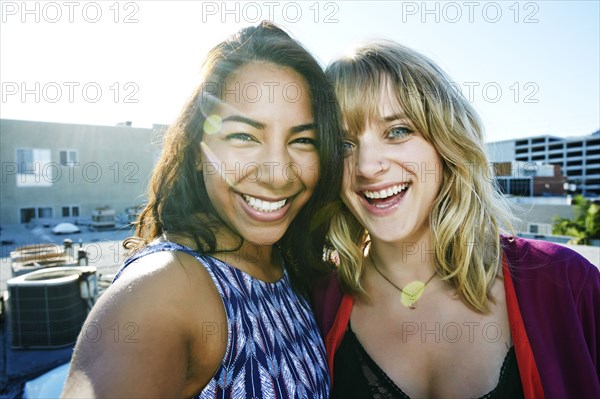 Women hugging on urban rooftop