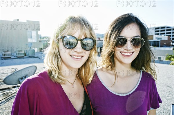 Women smiling on urban rooftop