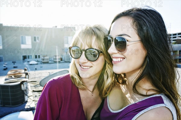 Women hugging on urban rooftop