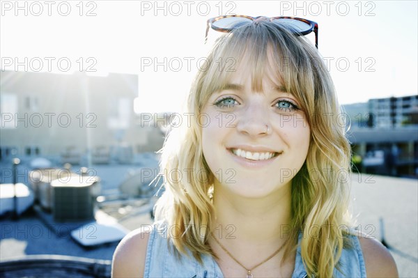 Caucasian woman smiling on urban rooftop