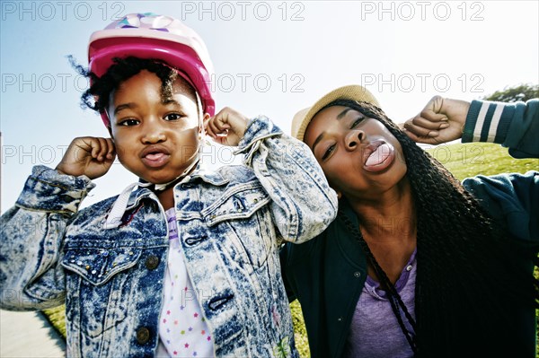 Black mother and daughter making faces