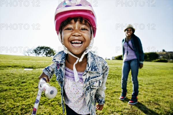 Black mother and daughter playing in park