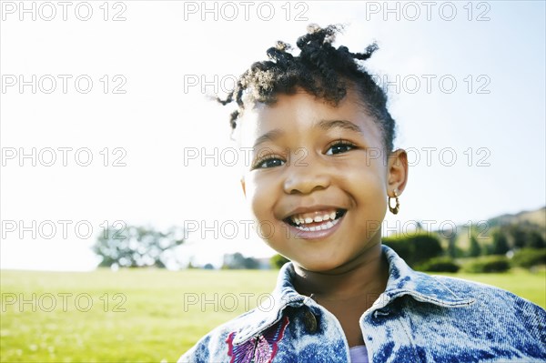 Black girl smiling outdoors