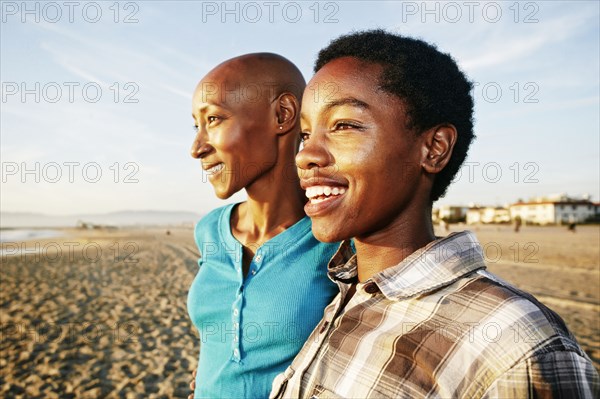 Black women smiling on beach