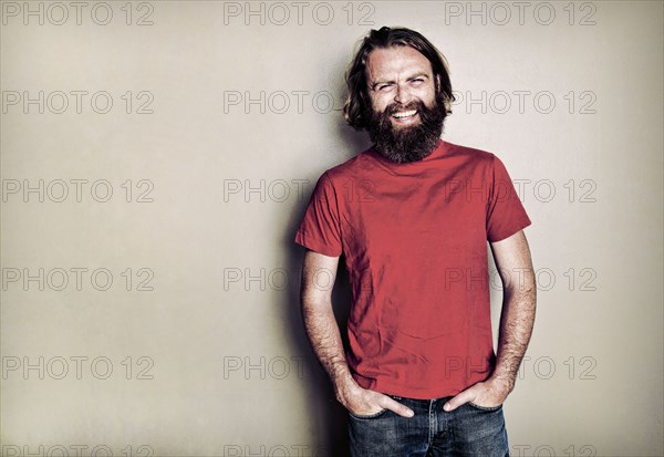 Caucasian man standing with hands in pockets