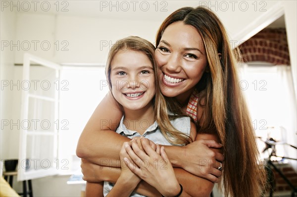 Native American mother and daughter hugging