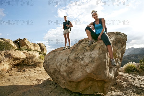 Women standing on rock formation