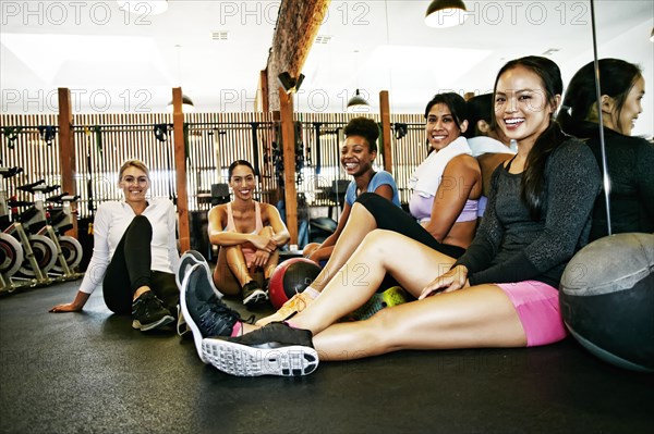 Friends smiling in gymnasium