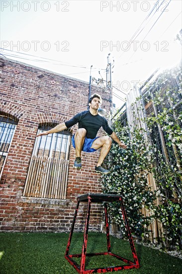 Caucasian man working out in outdoor gymnasium