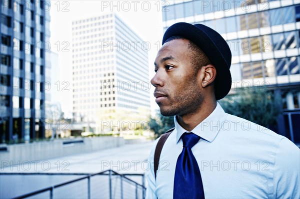 Black businessman standing outside office building