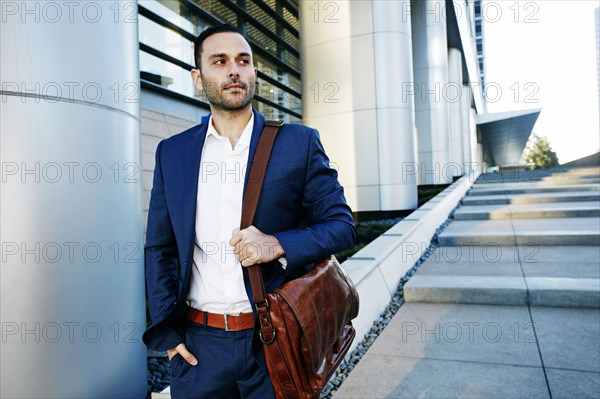 Caucasian businessman walking outside office building