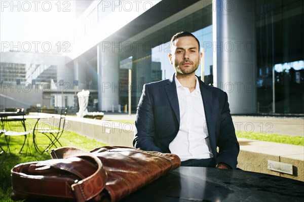 Caucasian businessman sitting outdoors