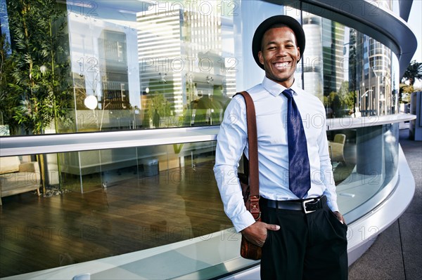 Black businessman smiling outside office building