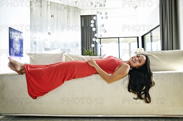 Chinese woman laying on sofa