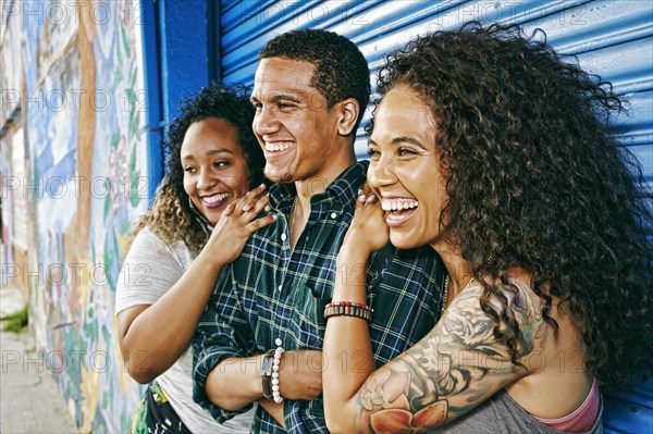 Friends smiling at garage door